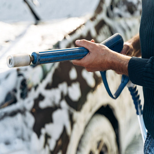 polar valve-cropped view of the caucasian young man holding hose